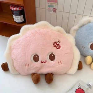 Close-up of a cute pink dumpling-shaped electric hot water bottle with soft plush fabric