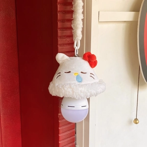 Detail of hanging cat plush night light with red bow and white faux fur rope