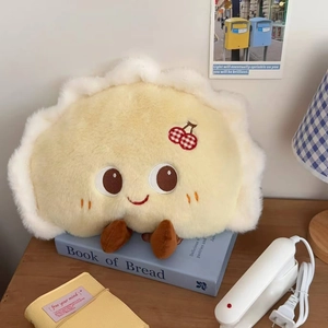 Detail of plush dumpling-shaped heating bag with cute face and cherry embroidery