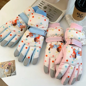 Detail of warm winter skiing gloves with cute puppy pattern and adjustable wrist straps