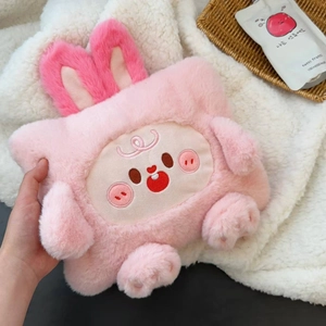 Close-up of pink plush hot water bottle with cute cartoon pig face and long bunny ears