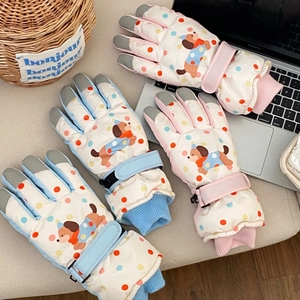 Detail of waterproof cartoon puppy ski gloves showing touchscreen tips and adjustable wrist straps