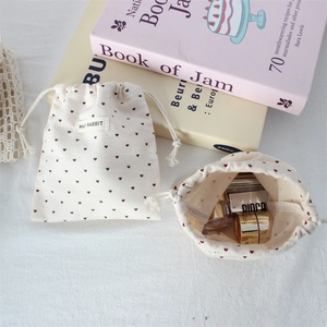 Cute polka dot drawstring pouch set with heart prints and brand label for small items