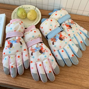 Detailed view of thermal ski gloves with cute cartoon dog patterns and anti-slip fingertips