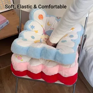 Thick flower-shaped plush lumbar cushions with Luck embroidery on a chair