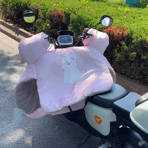 Close-up of pink cartoon dog scooter leg cover with thick fleece lining and handlebar mitts