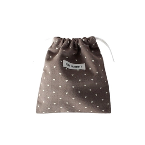 Coffee brown velvet drawstring storage pouch with white heart patterns and brand label