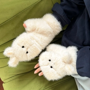 Detail of soft cream plush convertible gloves featuring cute bear face and fingerless design