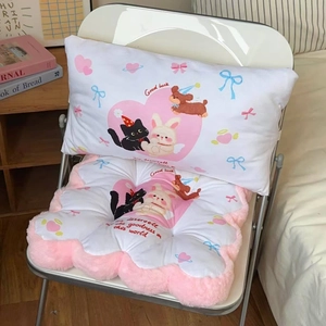 Close-up of cute pink cartoon chair cushion with plush edges and Good Luck embroidery