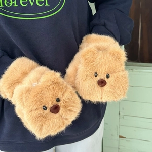 Close-up of the plush faux fur texture and cute bear face details on the winter gloves