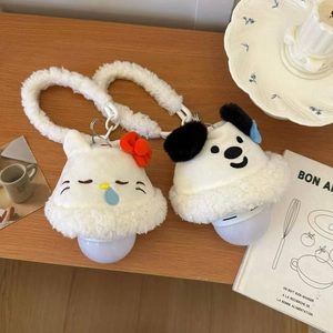 Detail of cute cat and dog plush night lights with soft glowing bulbs on wooden table