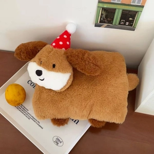 Detail of plush dog hot water bottle with Christmas hat on a minimalist tray