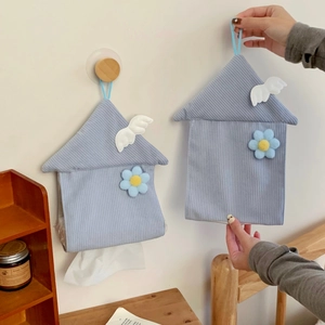 Detail of blue corduroy house-shaped hanging tissue box with white wings and flower decor