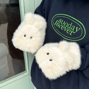 Detailed view of the soft beige faux fur material and cute rabbit design on plush mittens