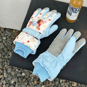 Detail of blue ski gloves showing anti-slip palm and cartoon puppy design