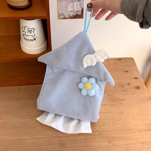 Detail of blue corduroy tissue box in house shape with wings and blue flower accent