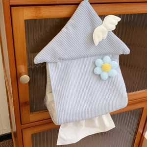 Detail of hanging house-shaped light blue corduroy tissue box with white wing decor