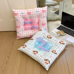 Detail of checkered square seat cushions featuring cute cartoon cat and bear patterns