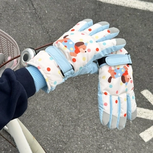 Detail of cartoon puppy ski gloves with adjustable velcro strap and non-slip fingertips