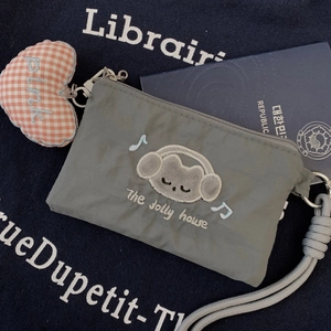 Detail of grey nylon cat coin purse with embroidered kitty and heart charm accessory