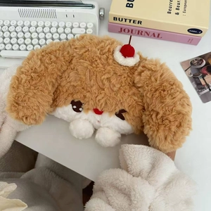 Macro detail of plush cartoon dog hot water bag with soft brown fur and cherry ornament