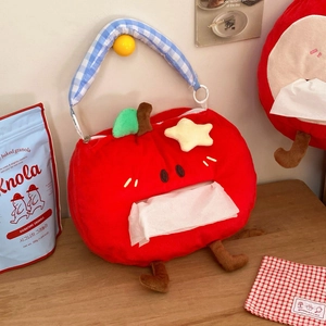 Close-up of a plush red apple tissue holder with soft fabric texture and leaf detail