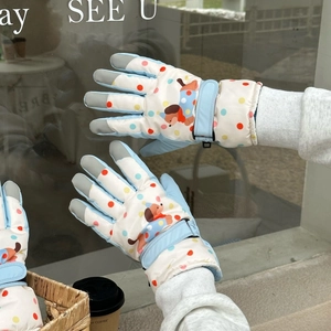 Close-up of winter cartoon puppy gloves showing touchscreen tips and wrist strap