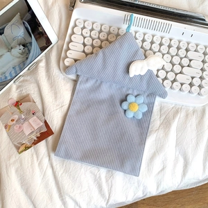 Detail of light blue corduroy house tissue box with cute white wings and flower decor