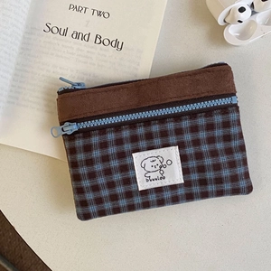 Close-up of double-zipper suede plaid card wallet with cartoon dog label and fabric detail