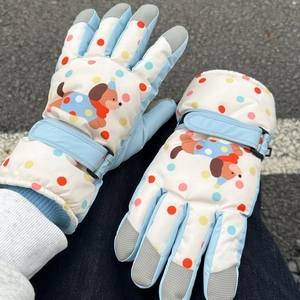 Detail of dog print ski gloves showing non-slip fingertips and adjustable velcro straps