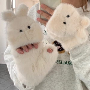 Detail of white plush rabbit mittens with fluffy long faux fur and cute animal ears