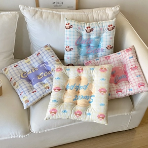 Detail of checkered square cushions with bear patterns and nine-hole quilting texture