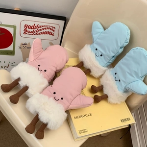 Close-up of creative cartoon mittens with plush trim on a minimalist leather chair