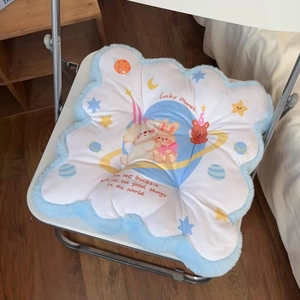 Detail of cloud-shaped plush chair cushion with cute cartoon bear and rabbit prints