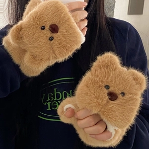 Close-up of fluffy brown bear plush fingerless gloves with soft texture and 3D ears