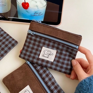 Close-up of retro suede card holder with plaid patchwork and cute bear label