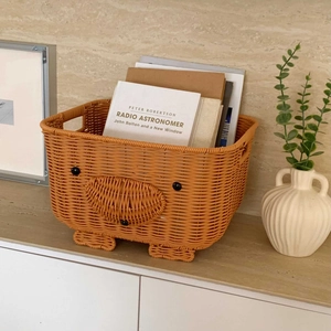 Close-up of cute pig-shaped woven storage basket with sturdy side handles and ample space