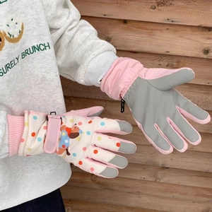 Close-up of waterproof ski gloves with cartoon dog prints and non-slip palms