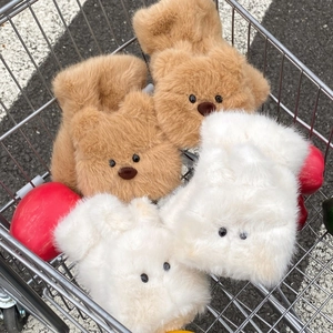 Close-up of cute plush bear-shaped winter gloves with soft faux fur texture in a cart