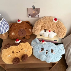 Detailed view of plush cartoon animal hand warmers with cherry decor on wooden shelves