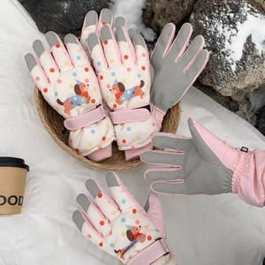 Detail of cartoon puppy ski gloves showing anti-slip palms and adjustable wrist straps