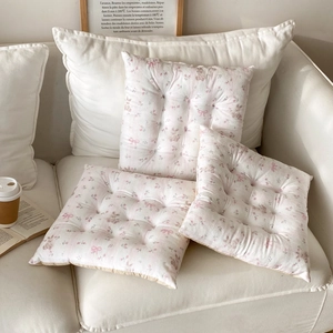 Quilted floral chair cushions with pink bows on soft cream fabric detail