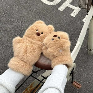 Close-up of plush brown bear mittens featuring 3D cartoon bear head and soft faux fur
