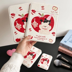 Close-up of cute bear and apple illustration on a quilted cream makeup mirror case