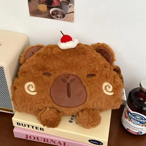 Detail of cute brown plush bear hot water bottle with cherry decor on aesthetic books