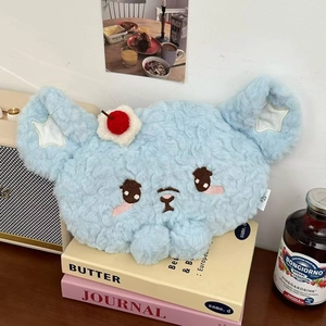 Detail of cute light blue plush bear electric hand warmer with soft curly fur texture