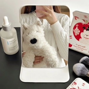 Foldable desktop makeup mirror in white finish reflecting a lifestyle vanity setting