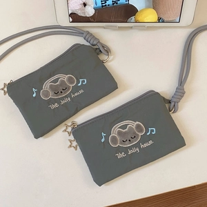 Detail of gray nylon pouch with cartoon cat embroidery and star zipper pull