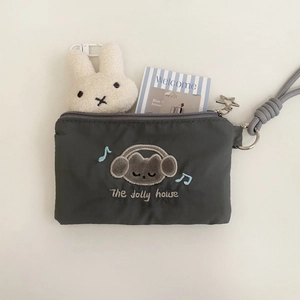 Detail of dark gray nylon card holder with cat embroidery and star pendant zip