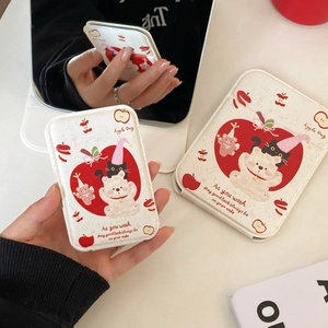 Detail of cute bear and apple illustration on a portable white folding makeup mirror